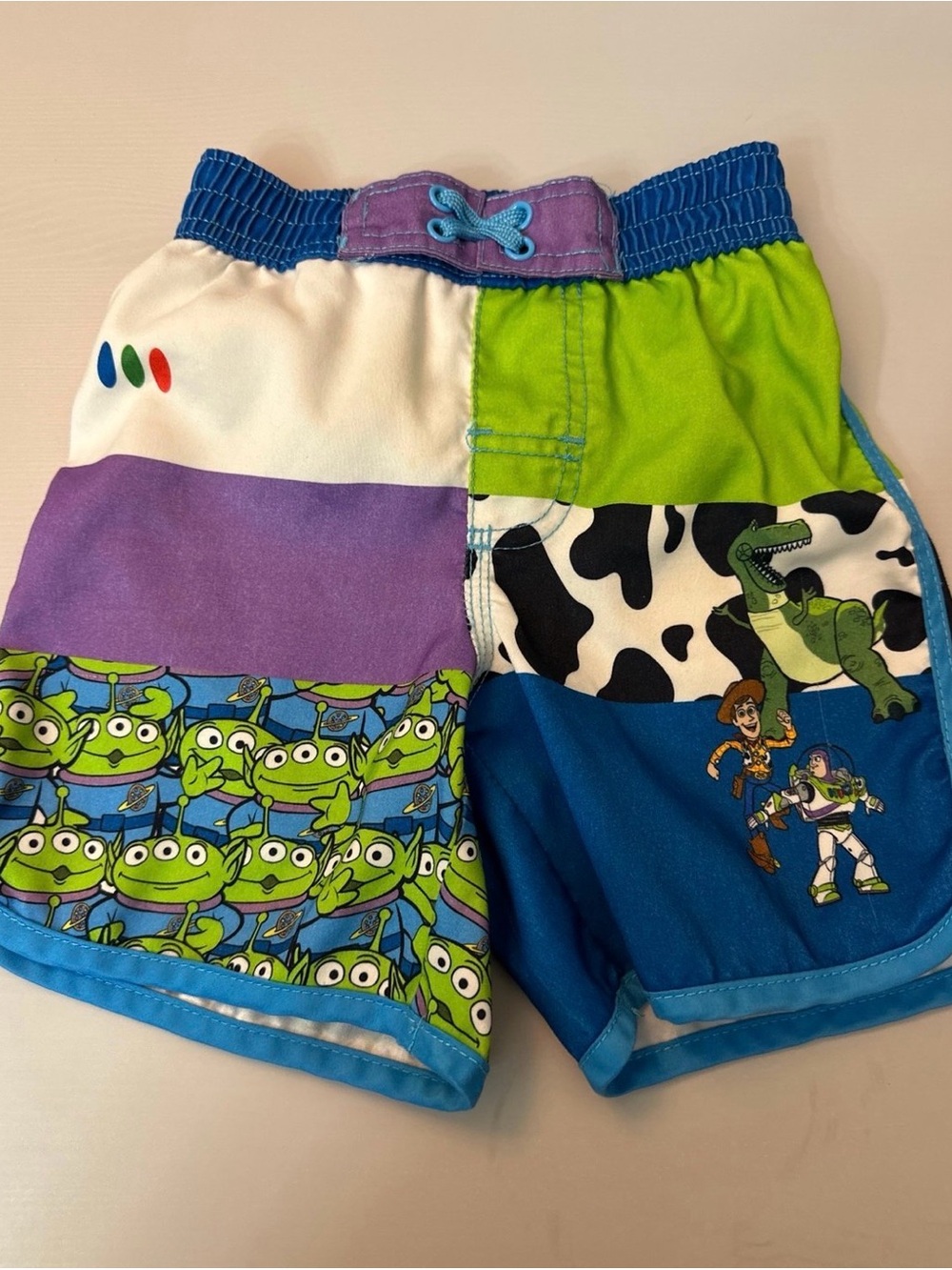 Disney Toy Story Patchwork Swim Shorts in Blue, Green & Purple